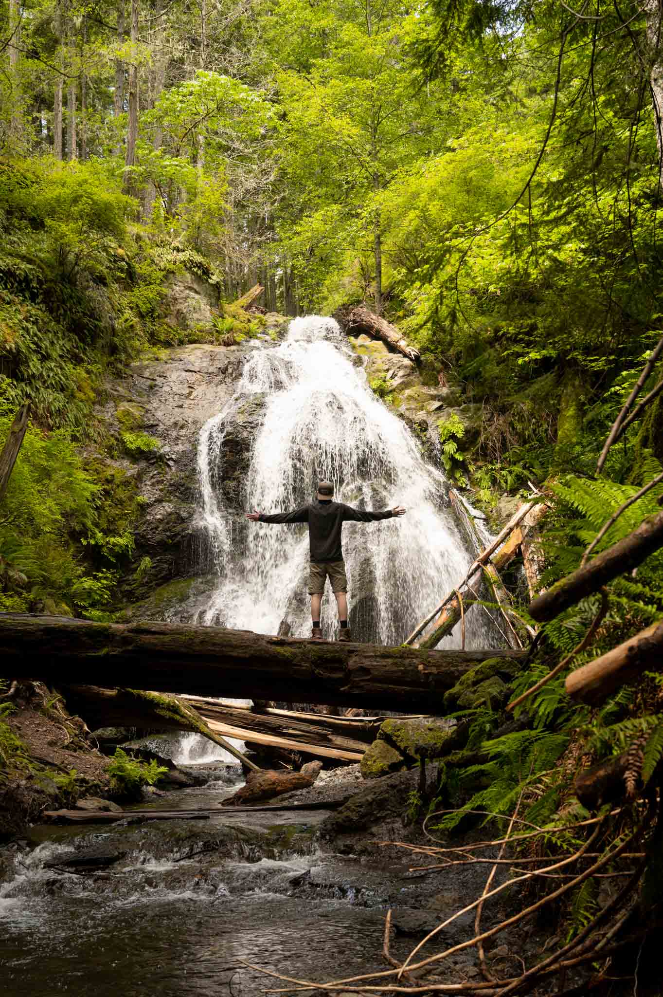 Washington hiker in front of waterfall sharing Things to do on Orcas Island