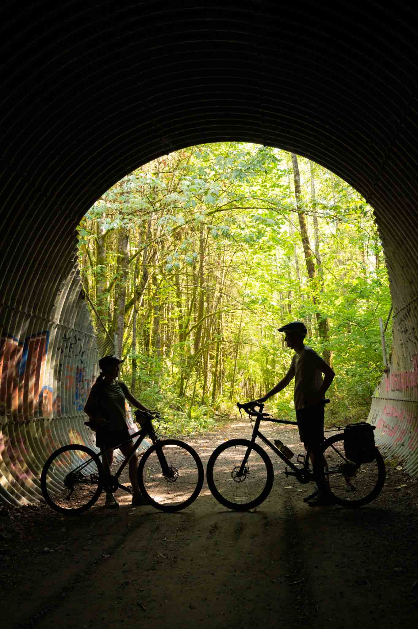 Seattle couple riding bikes in a tunnel and sharing things to do in North Bend Washington