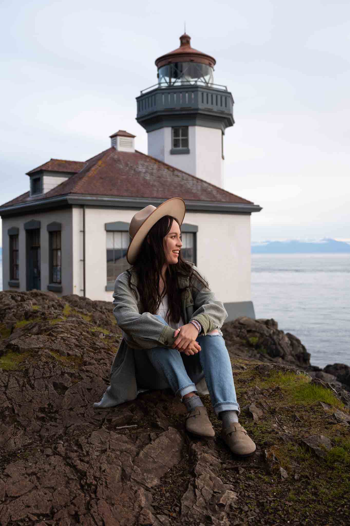 Adventure travel writer in front of Lime Kiln Lighthouse on San Juan Island
