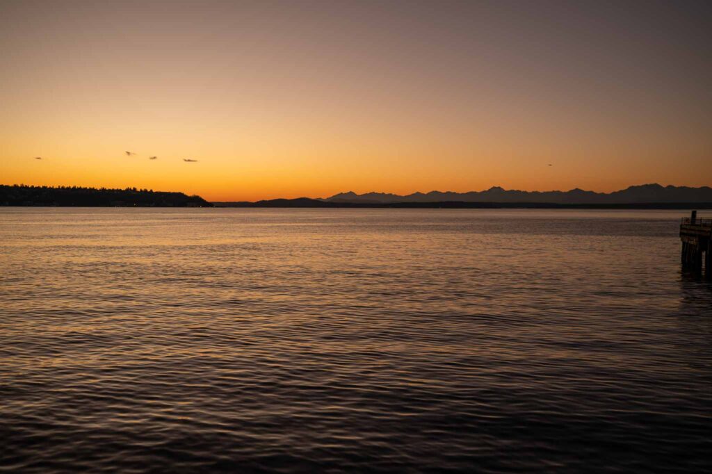 Sunset over the Seattle waterfront with the Olympic Mountains